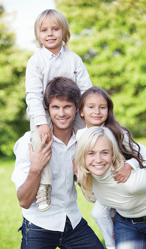 happy family of four enjoying outdoors with two children smiling together and playful moments representing family love and connection 7 memorable moments