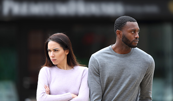 man and woman standing apart showing tension and conflict in relationship emotional struggle and disagreement